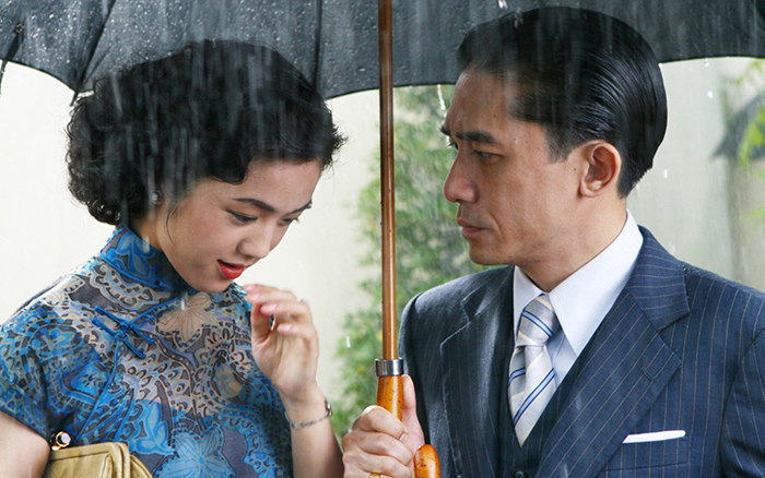 asian man and woman under an umbrella in the rain