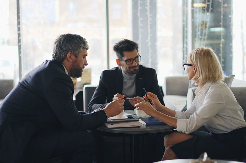 2 men and 1 woman meeting